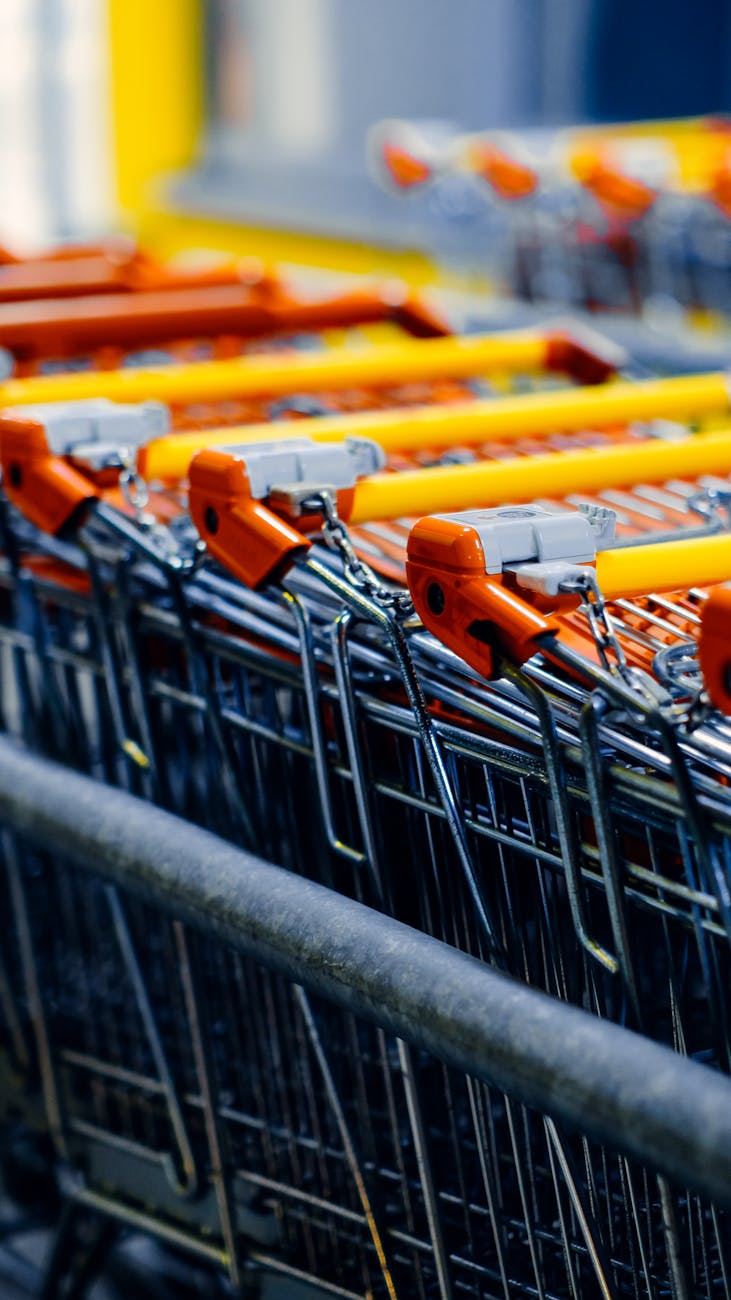 row of shopping carts with orange handles